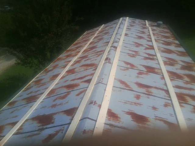 Rusted metal roof panels with new wood purlins before replacement — Storm Damage Roof Repair in Conway by Roofing Brothers